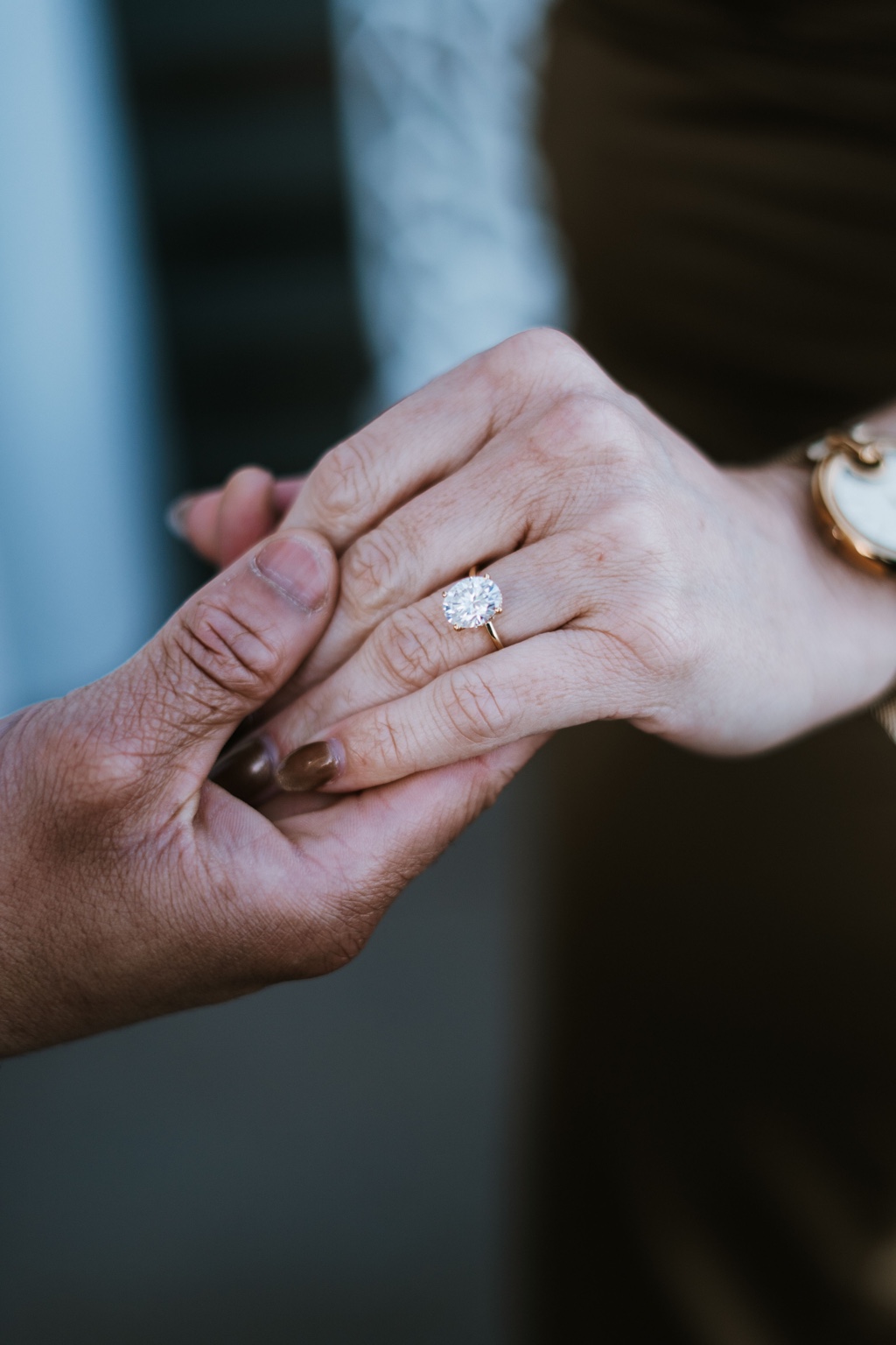 Meagan's engagement ring as she holds Yohance's hand